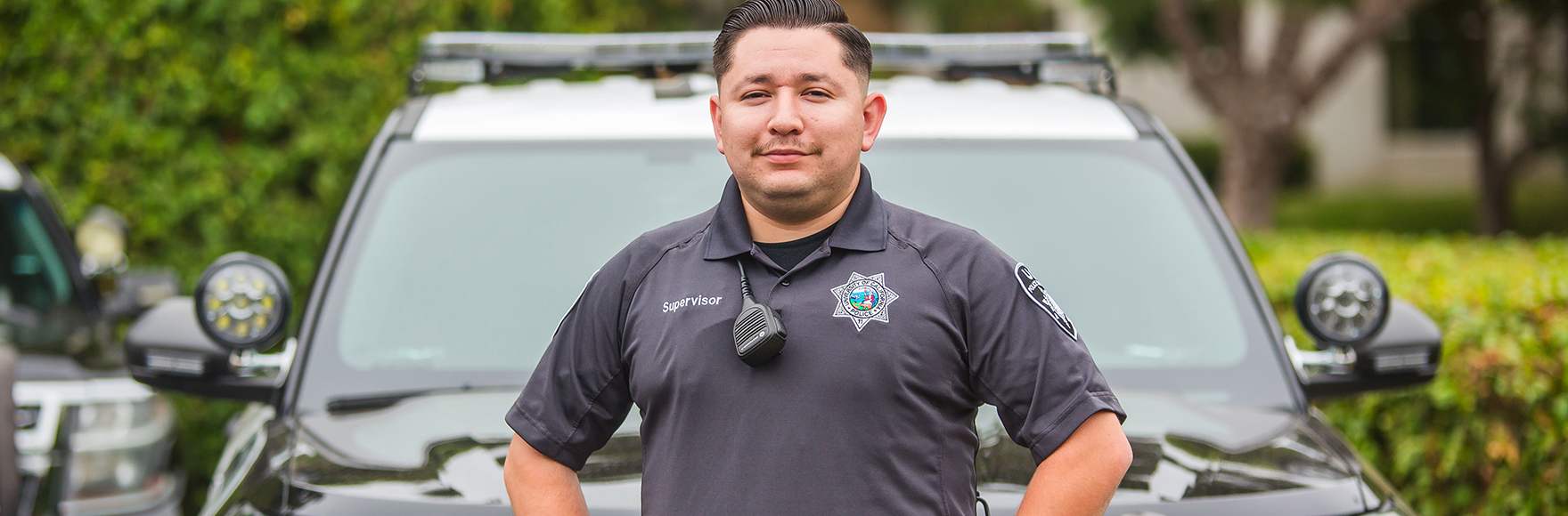 Public Safety Responder smiling in front of car